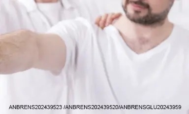 homem adulto com a ajuda de um profissional realiza exercícios de mobilidade ou fortalecimento muscular